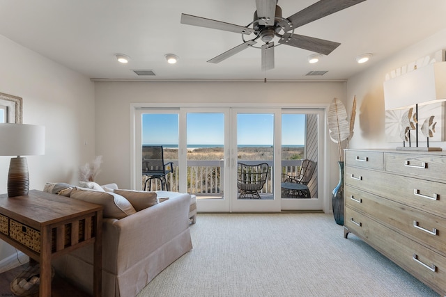 carpeted living room featuring ceiling fan