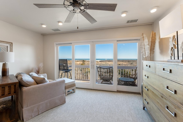 living area featuring ceiling fan and light carpet