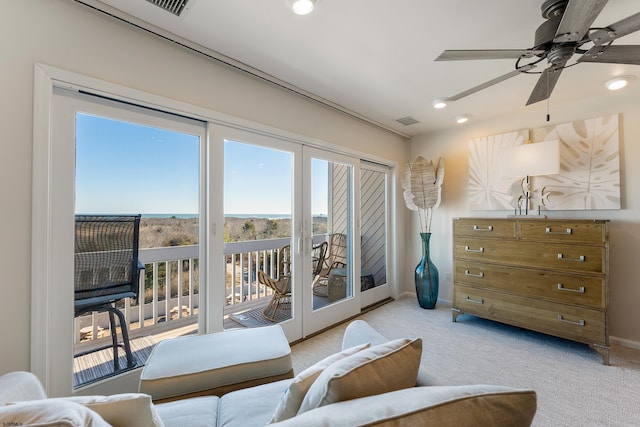 interior space featuring french doors, ceiling fan, and light carpet