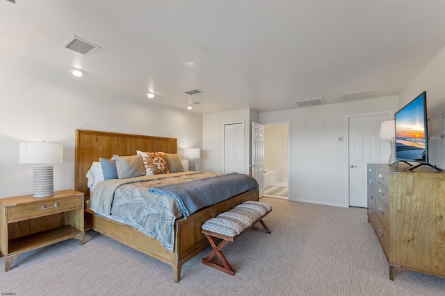 carpeted bedroom featuring ensuite bath