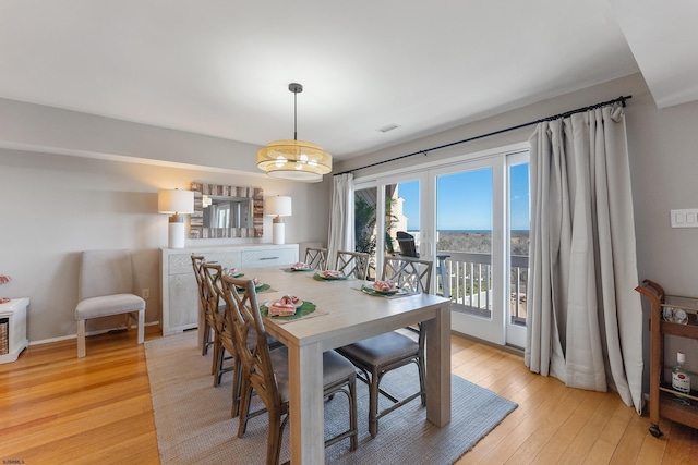 dining space with light hardwood / wood-style floors