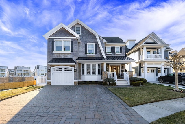 craftsman-style house with a garage, a front lawn, and a porch