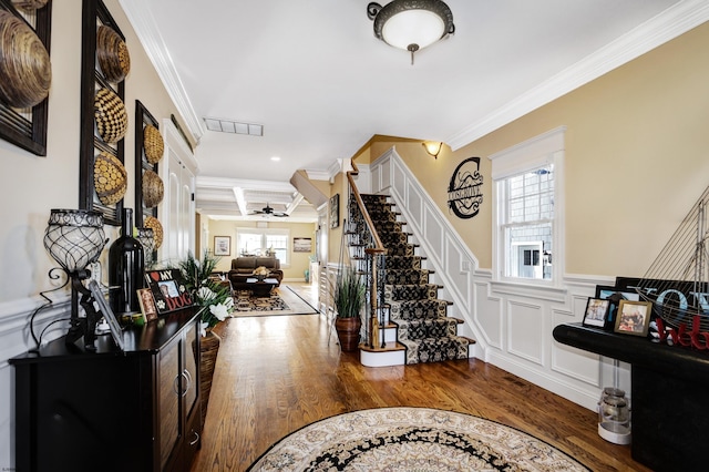 foyer entrance featuring coffered ceiling, crown molding, dark hardwood / wood-style floors, beamed ceiling, and ceiling fan