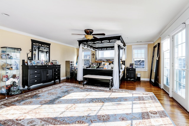 bedroom featuring dark wood-type flooring, ceiling fan, and ornamental molding