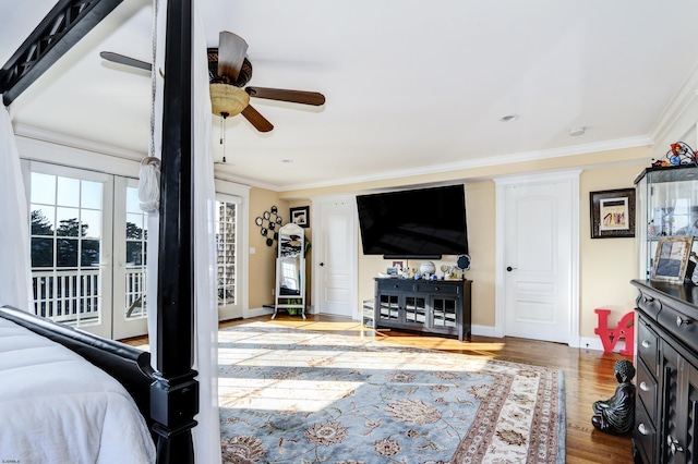 bedroom with ornamental molding, wood-type flooring, and access to outside