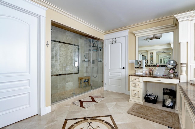 bathroom with an enclosed shower, vanity, and ornamental molding