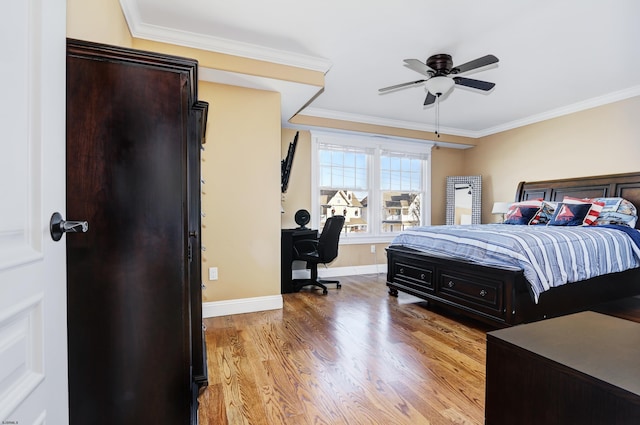 bedroom featuring crown molding, light hardwood / wood-style flooring, and ceiling fan