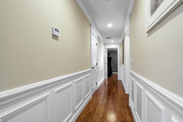 hall with crown molding and dark wood-type flooring