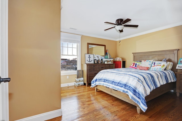 bedroom featuring ornamental molding, hardwood / wood-style floors, and ceiling fan