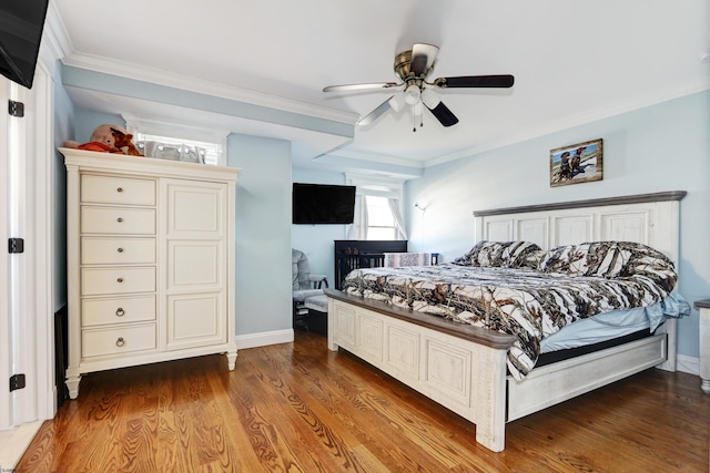 bedroom featuring crown molding, hardwood / wood-style floors, and ceiling fan