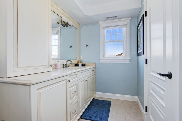 bathroom with tile patterned floors, plenty of natural light, and vanity