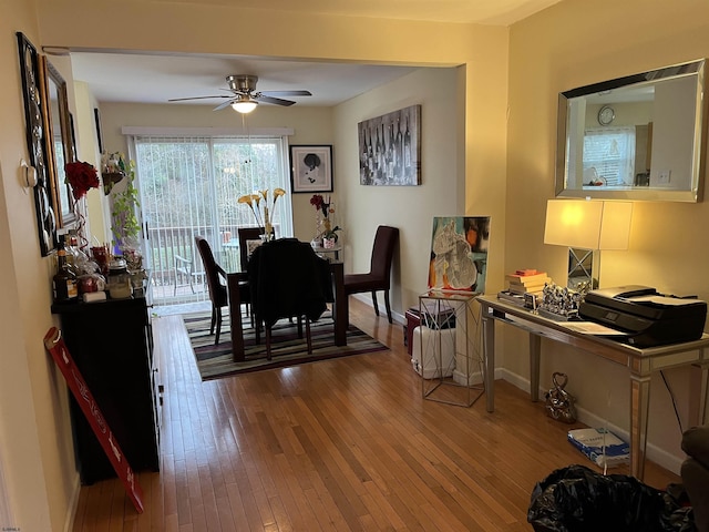 dining room featuring wood-type flooring and ceiling fan