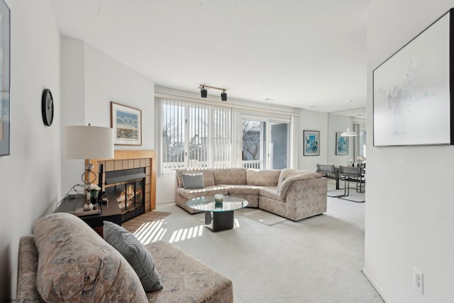 living room featuring carpet flooring and a tile fireplace