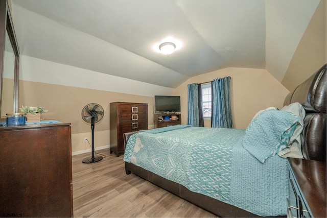 bedroom featuring light hardwood / wood-style flooring and vaulted ceiling