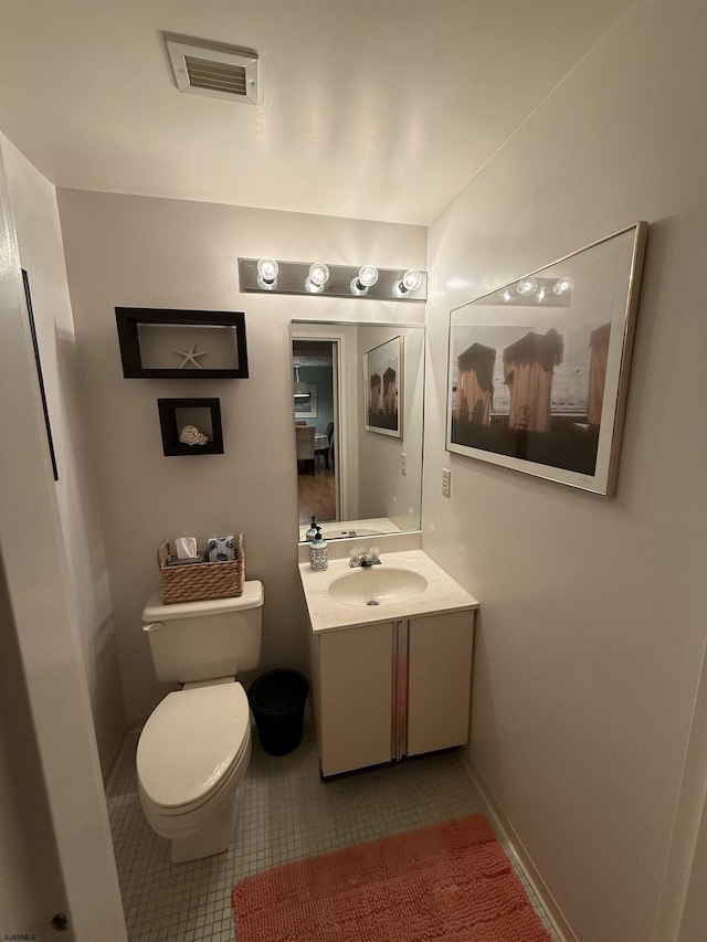 bathroom with vanity, toilet, and tile patterned flooring