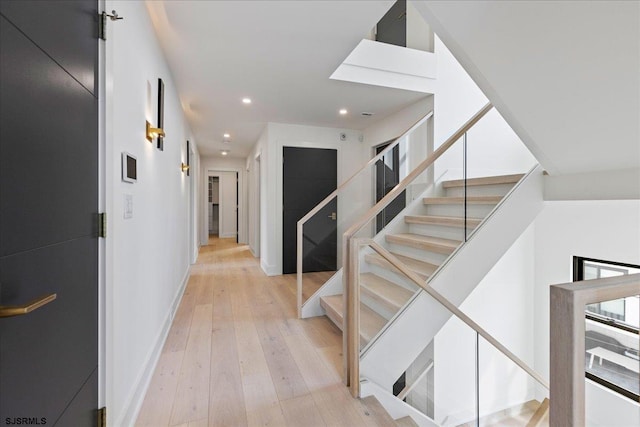 stairs featuring hardwood / wood-style floors