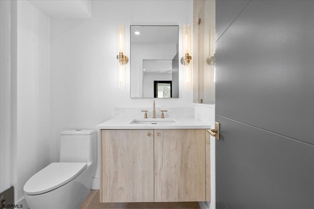 bathroom featuring vanity and toilet