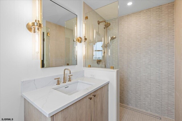 bathroom featuring vanity and a tile shower