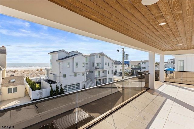 balcony featuring a water view and a beach view