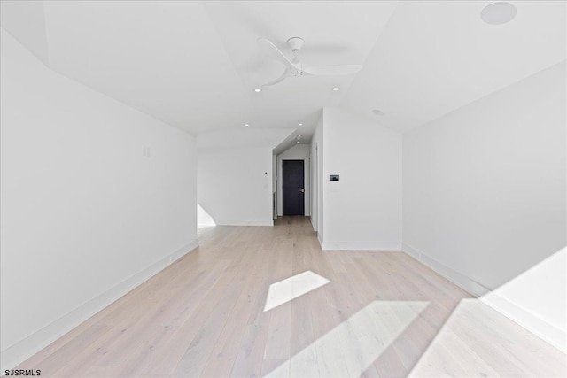 additional living space featuring lofted ceiling and light wood-type flooring