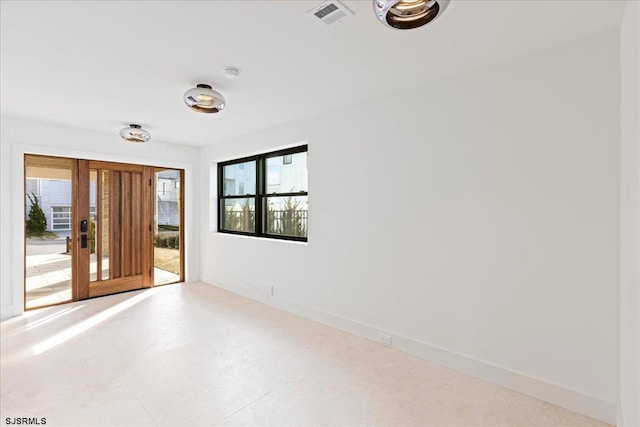 spare room featuring plenty of natural light and french doors