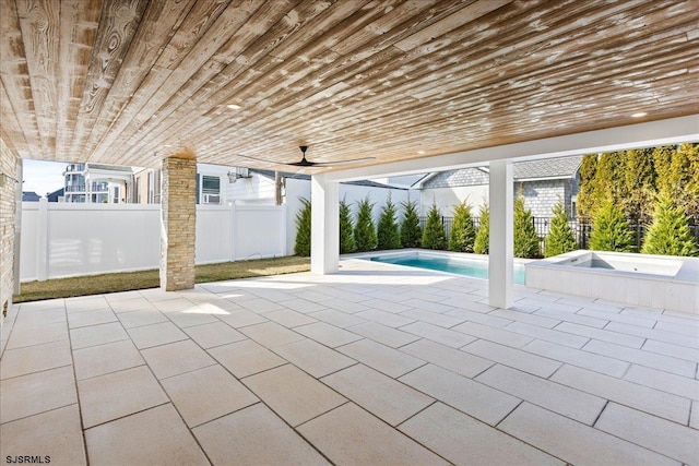 view of patio with a pool with hot tub