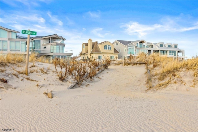 exterior space with a water view and a view of the beach