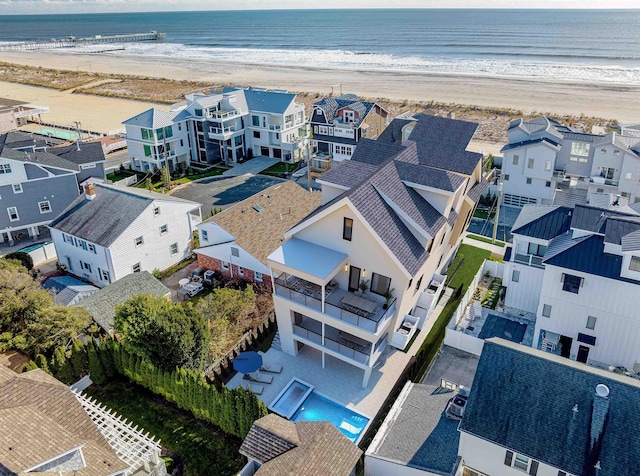 bird's eye view featuring a water view and a beach view