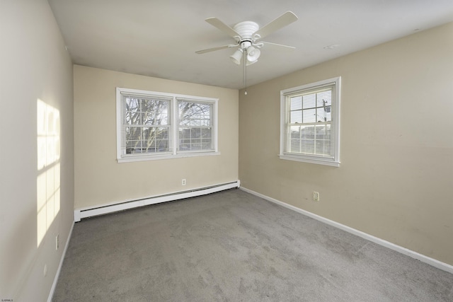 carpeted spare room with baseboard heating and ceiling fan