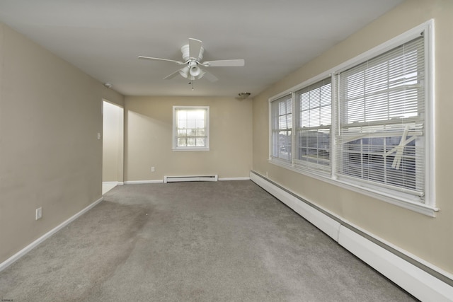 unfurnished room with a baseboard radiator, light colored carpet, and ceiling fan