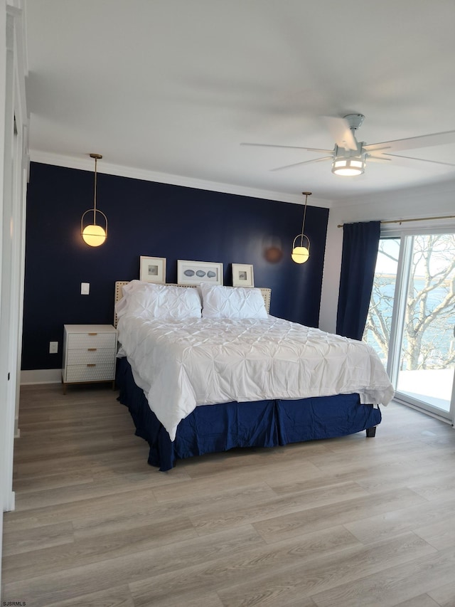 bedroom with ceiling fan, wood-type flooring, and access to exterior