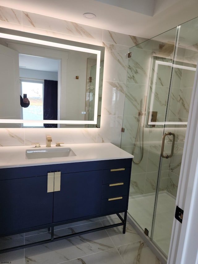 bathroom with vanity and a shower with shower door