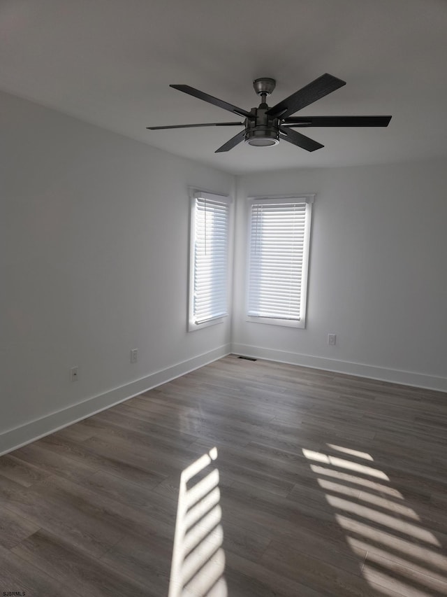 unfurnished room featuring dark hardwood / wood-style floors and ceiling fan