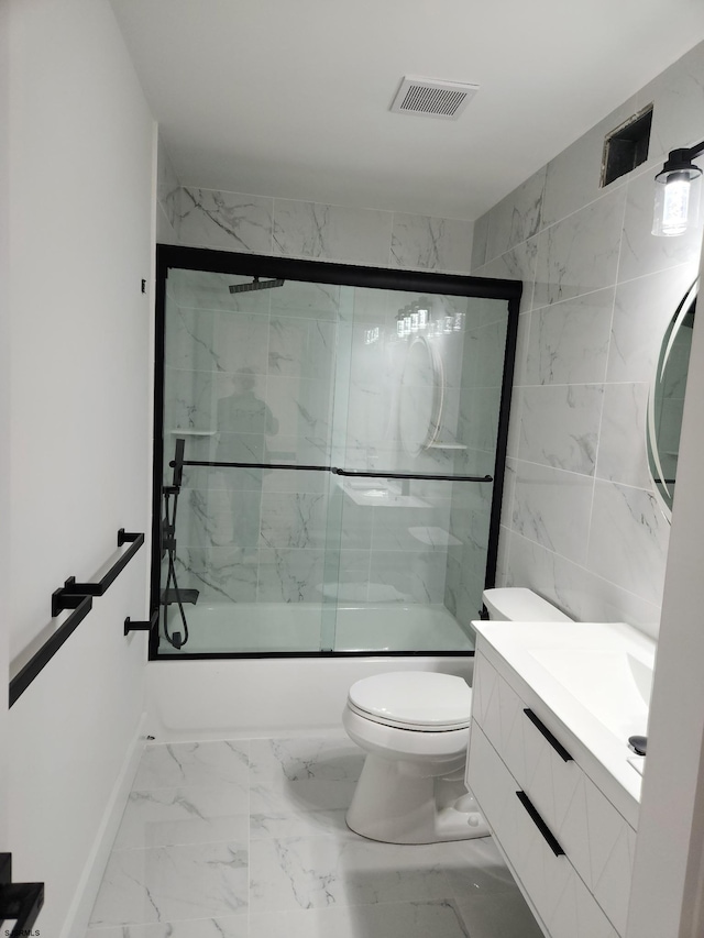 full bathroom with vanity, toilet, and combined bath / shower with glass door