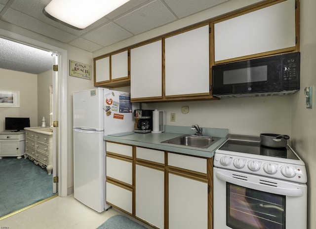 kitchen featuring white cabinetry, white appliances, a paneled ceiling, and sink