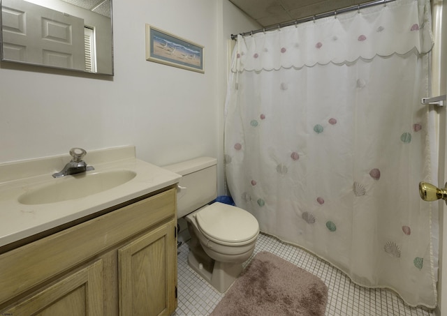 bathroom with vanity, tile patterned floors, and toilet