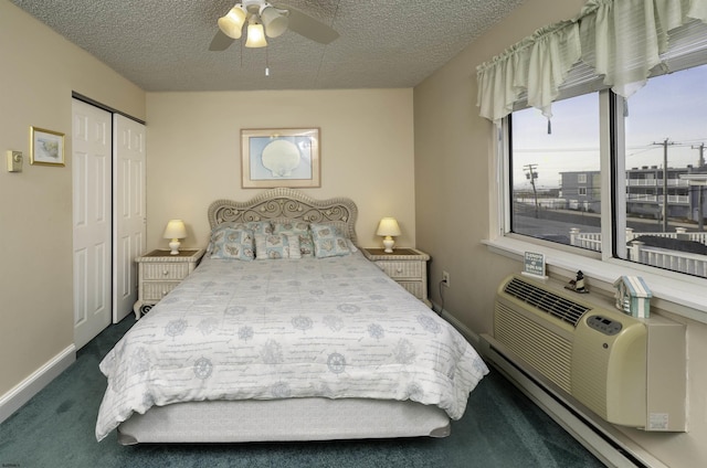 bedroom with a baseboard radiator, a closet, a textured ceiling, and dark colored carpet