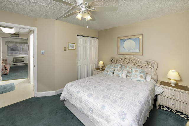 carpeted bedroom with ceiling fan, an AC wall unit, a closet, and a textured ceiling