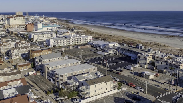 aerial view with a water view and a beach view