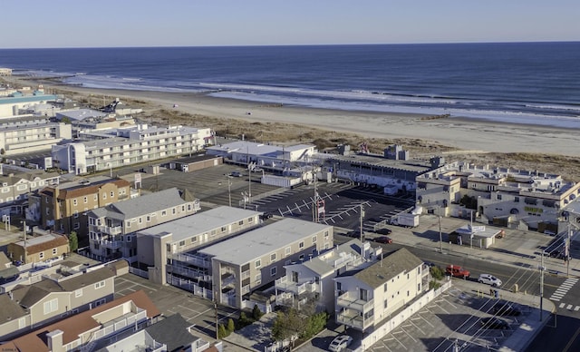 drone / aerial view with a beach view and a water view