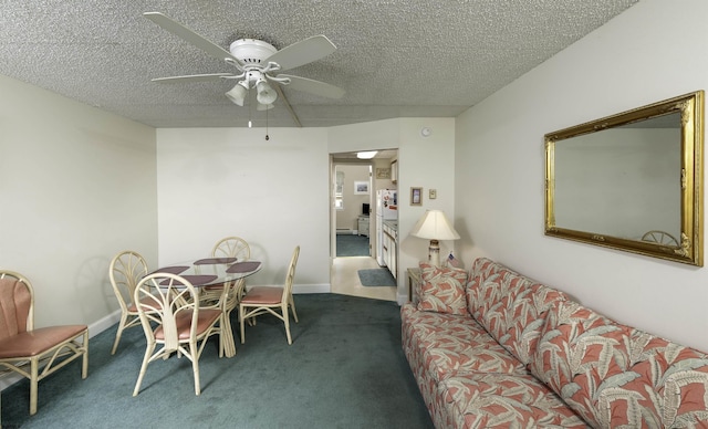 dining space with ceiling fan, a textured ceiling, and dark carpet