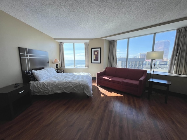 bedroom featuring dark wood-type flooring and a textured ceiling