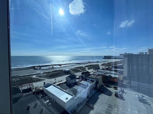 bird's eye view featuring a water view and a beach view