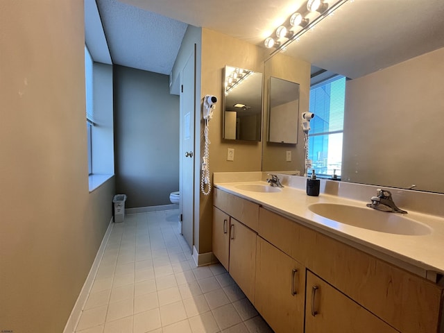 bathroom featuring tile patterned floors, vanity, and toilet