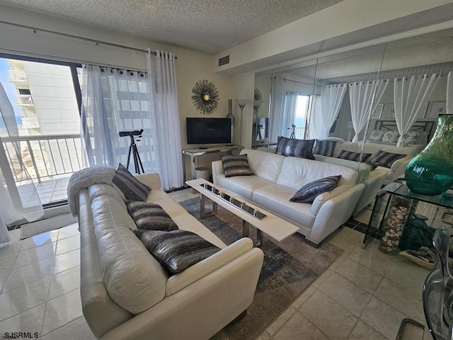 tiled living room with a textured ceiling