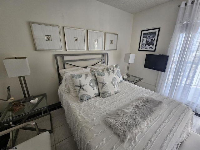 tiled bedroom featuring a textured ceiling