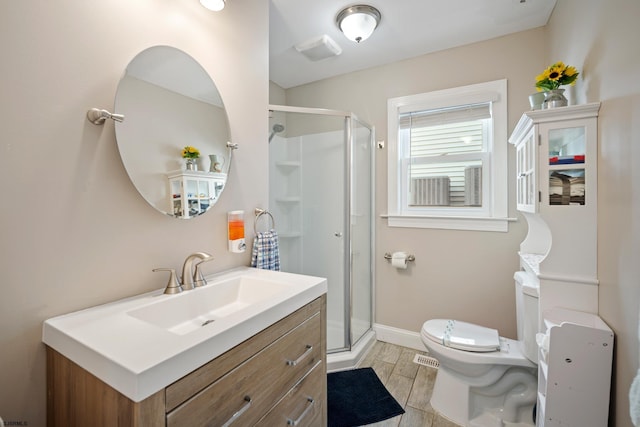 bathroom with toilet, vanity, and walk in shower