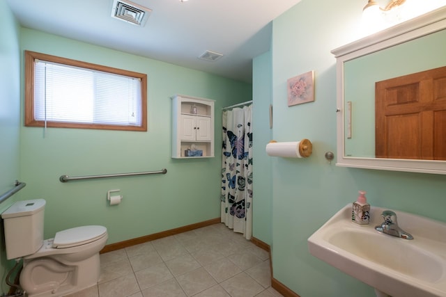 bathroom with sink, a shower with curtain, tile patterned floors, and toilet