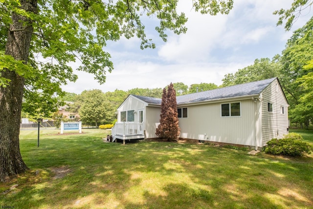 rear view of house featuring a yard