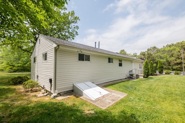 back of house with a lawn